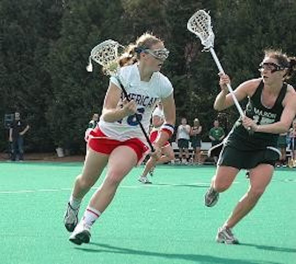 KEEP AWAY - Like in their game against George Mason (pictured here), the Eagles lost to Navy on Tuesday. Junior attacker Kira Sonberg scored a goal in the second half of play Tuesday. 