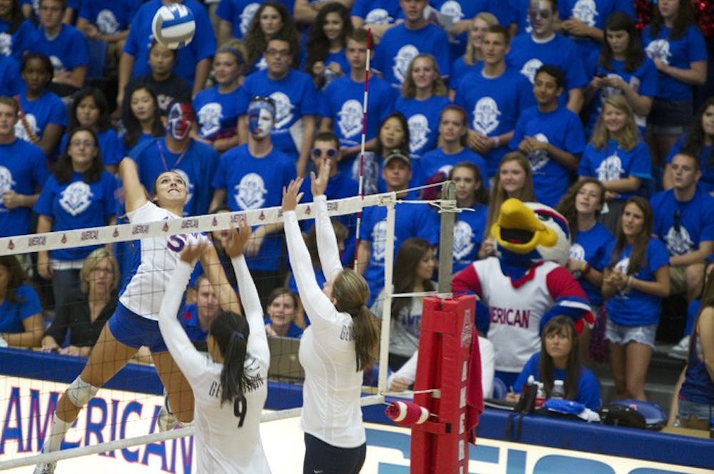 AU students watch as outside hitter Juliana Crum jumps for a spike against the Georgetown Hoyas on August 24.
