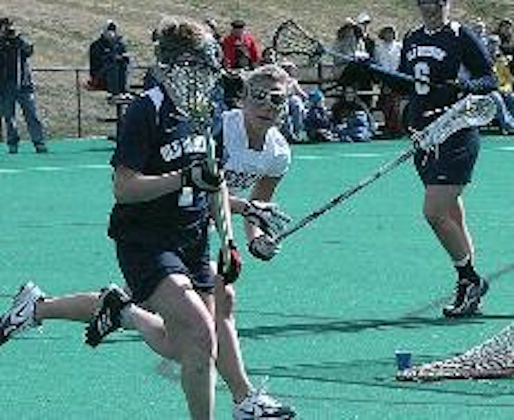 RUNNING  'TO-GET-HER' - An Old Dominion athlete attempts to score a goal with her teammate while an Eagle defender effortlessly runs at her side in an attempt to stop her and break up the play. The Eagles are now 1-3 on the season, having lost to Drexel a