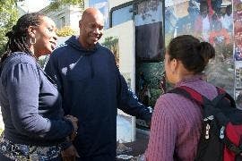 CAMPING FOR KENYA - Former NBA player and AU alum Kermit Washington and Dr. Teresa Gipson, medical coordinator for Project Contact, speak to Katherine de Juan, a senior in the School of International Service. Washington camped on the quad and fasted for f