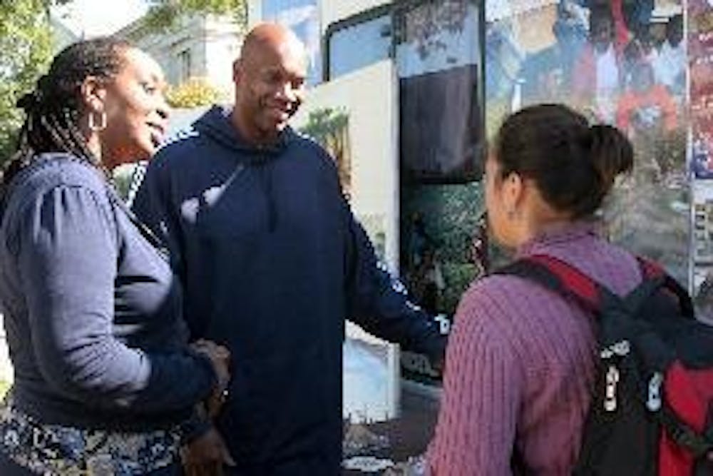 CAMPING FOR KENYA - Former NBA player and AU alum Kermit Washington and Dr. Teresa Gipson, medical coordinator for Project Contact, speak to Katherine de Juan, a senior in the School of International Service. Washington camped on the quad and fasted for f