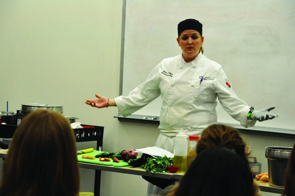 SPICING IT UP â€” Terrace Dining Room Executive Chef Mary Soto prepares spicy black bean chili during a cooking demonstration for students on Feb. 24.