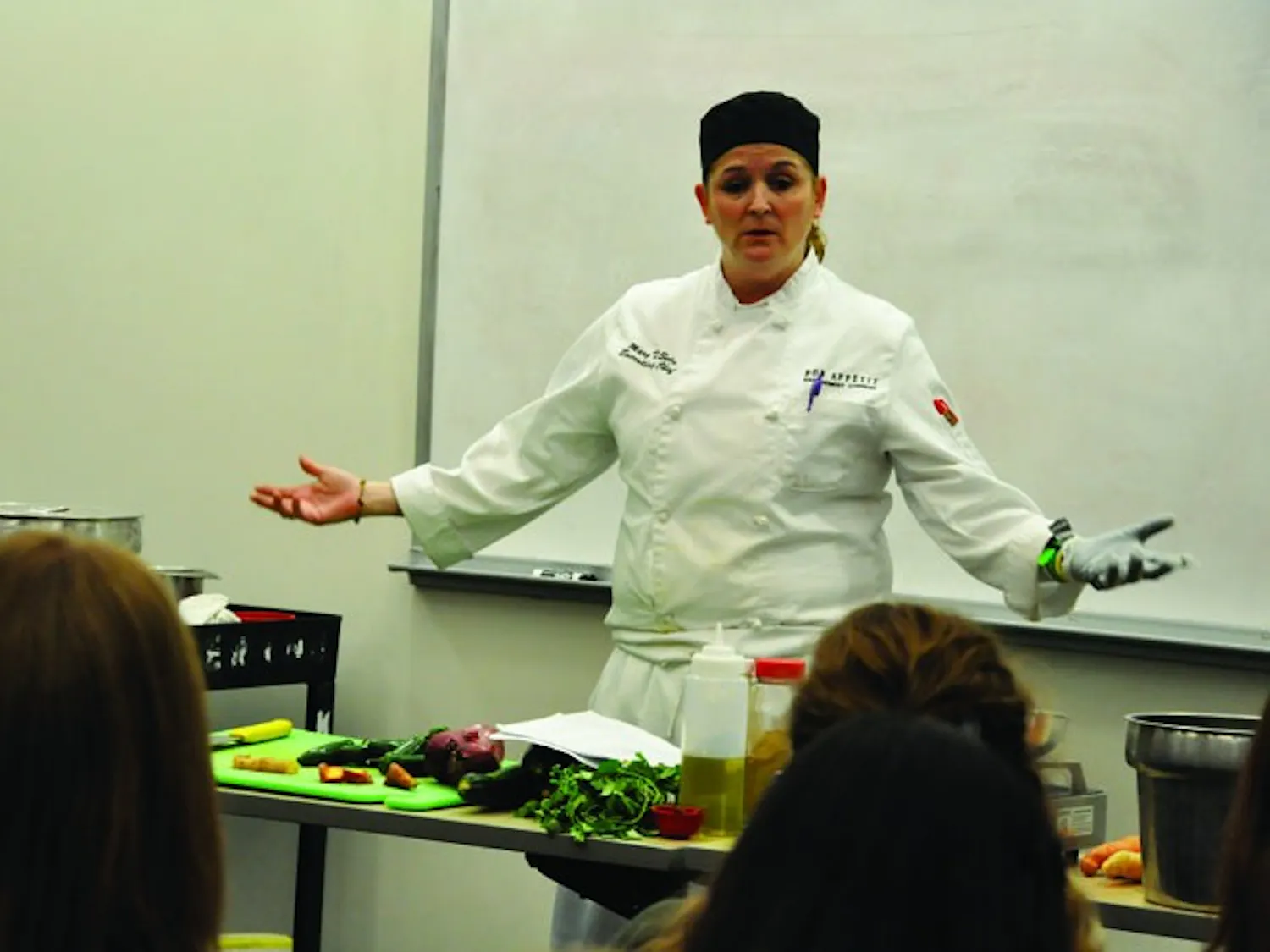 SPICING IT UP — Terrace Dining Room Executive Chef Mary Soto prepares spicy black bean chili during a cooking demonstration for students on Feb. 24.