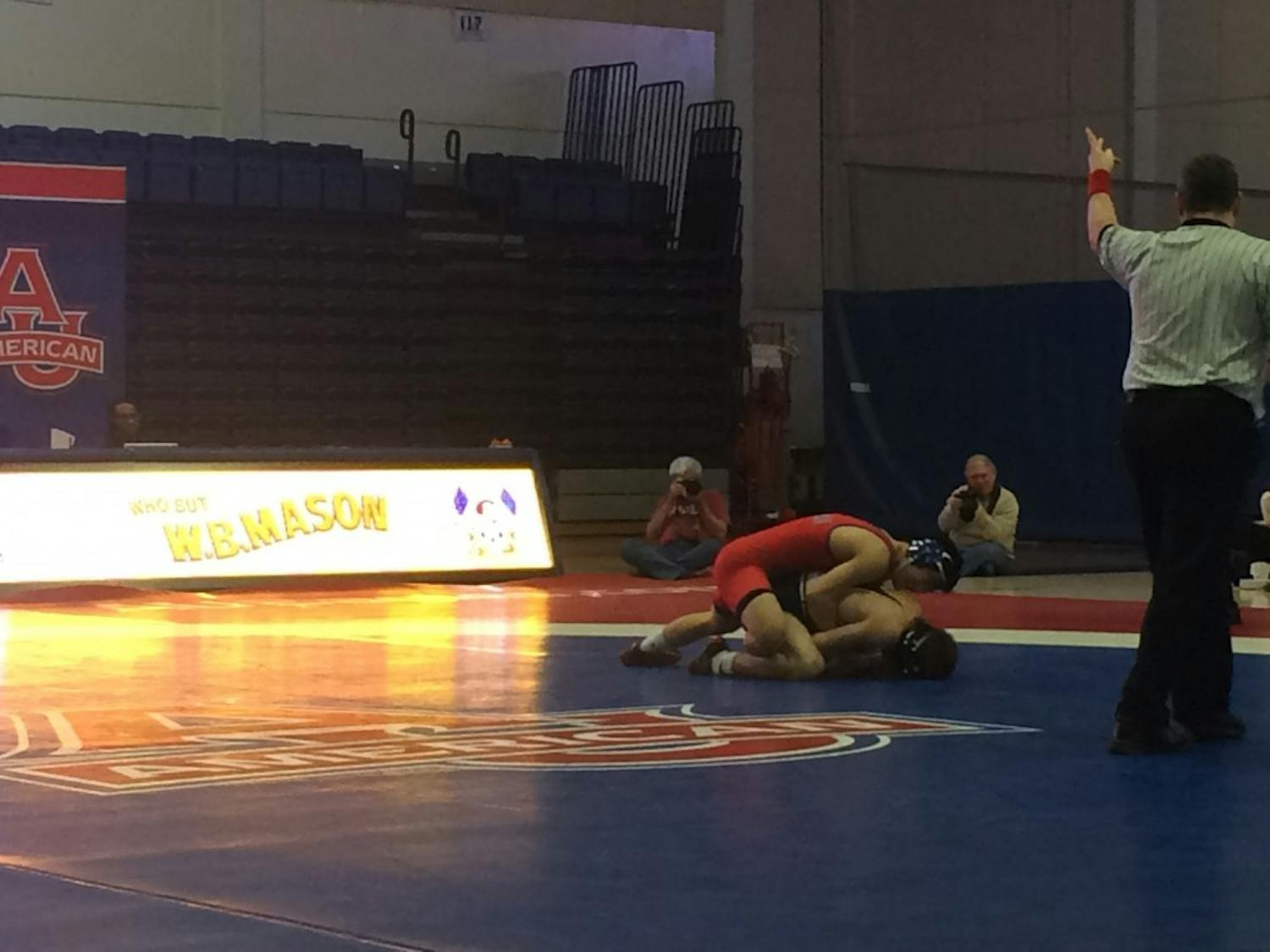 Redshirt junior Josh Terao (red) earns a 2-point takedown early in his match against Drexel's Austin DeSanto. 