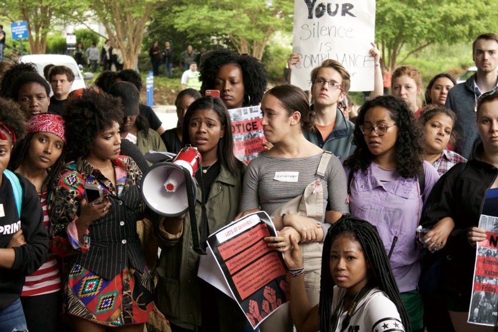 A student protester begins to cry as she speaks about how racism has affected her experience at AU. Student protesters blocked traffic in the Bender tunnel as they demanded support resources for students of color on May 5.&nbsp;