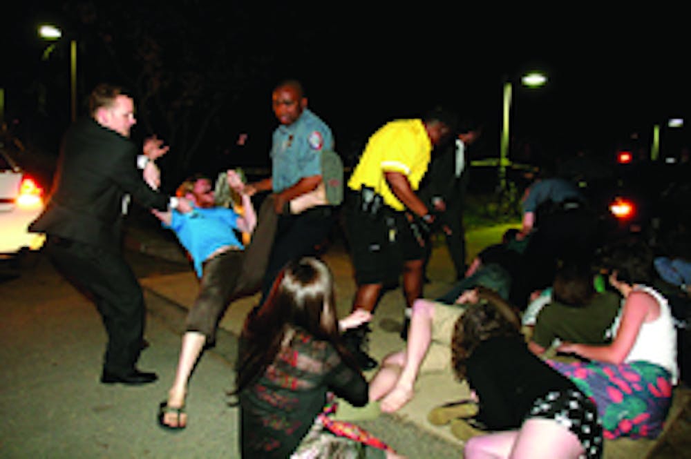 DELAYED CONSEQUENCES- SIx AU students were notified by the university Friday that they would be served with warrants for their arrests stemming from the April incident pictured above. At the time, 16 students attempted to block White House aide Karl Rove'