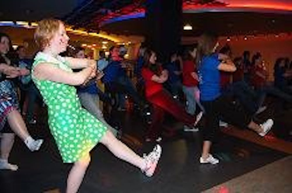 RAISING AWARENESS - Ravenna Motil-McGuire dances with other students in the Tavern on Friday night. Motil-McGuire organized the fundraiser as part of AIDS Awareness Week.