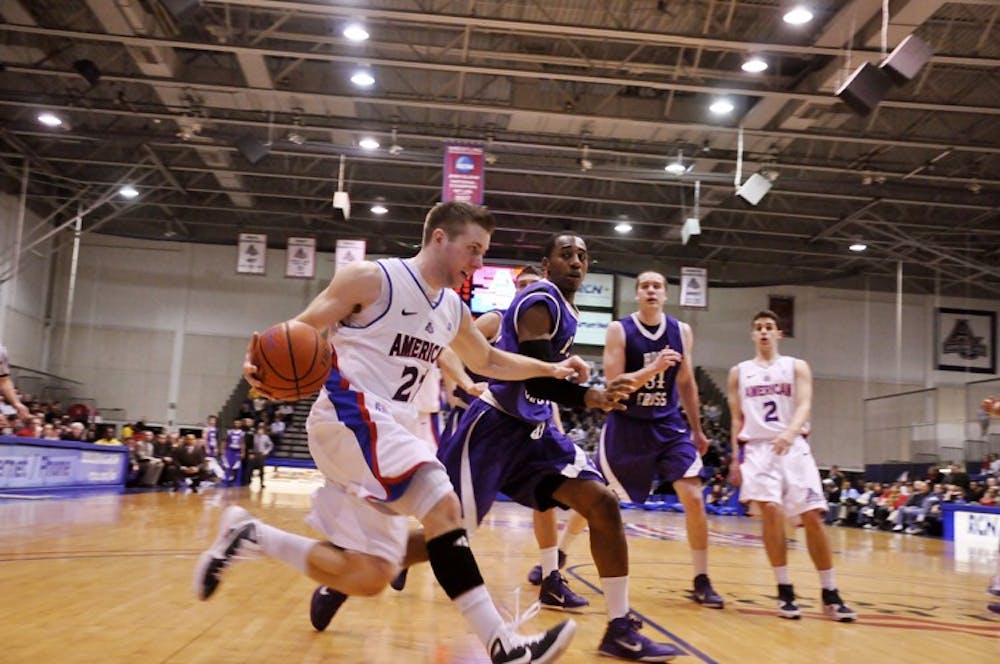TEAM PLAYER â€” Senior guard Nick Hendra dribbles by College of the Holy Cross defenders during AUâ€™s 64-60 win on Sunday.  Hendra finished with nine assists and 8 points. AU clinched the number two seed in  the upcoming Patriot League Tournament.