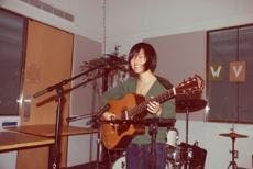 GUITAR HERO - Rising sophomore Kyoko Takenaka performs at one of WVAU's open mic nights this past year. Takenaka is just one of many AU students who have sung, performed or read poetry on stage.