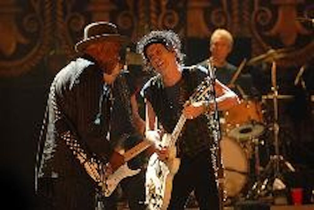 FARAWAY EYES - Stones' guitarist Keith Richards shares an intimate rock 'n' roll moment with blues legend Buddy Guy in Martin Scorsese's new documentary, "Shine a Light." Baby boomer critics have expressed their love for the film.