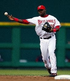 WHERE'S IT GOING? - Nationals short stop Christian Guzman tries to throw across the diamond to get the out at first. Only time will tell to see if his prediction on the Nats' end of season record is as accurate next fall.