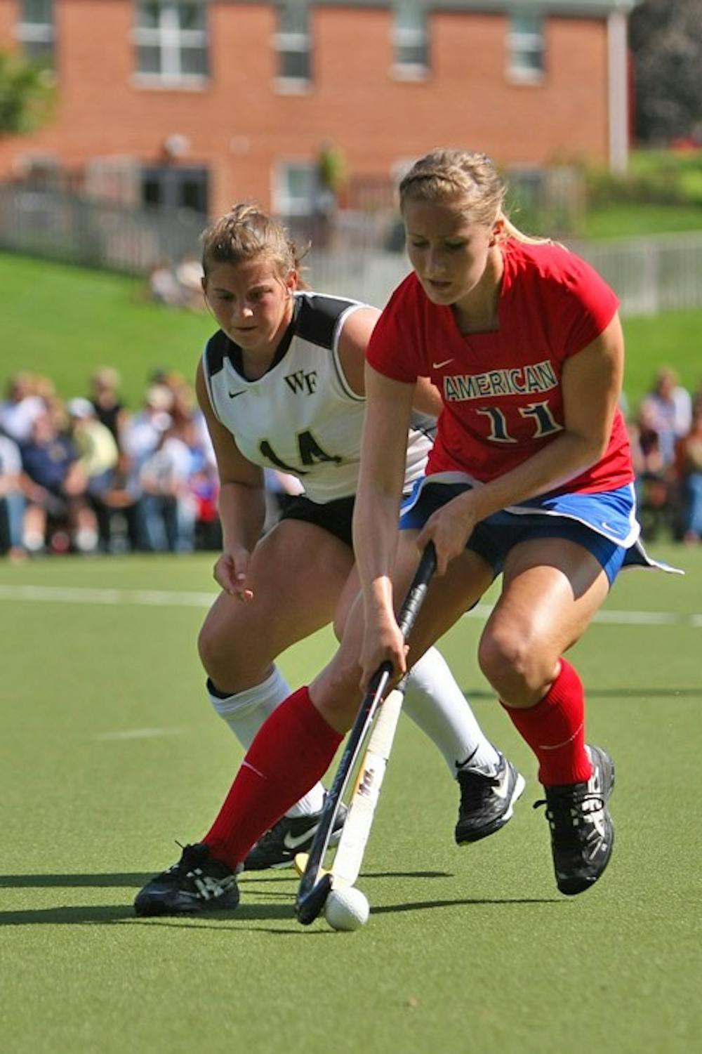 FAILING TO CAPITALIZE â€” AU freshman Kelsey Davis fights for a ball with a Wake Forest defender in their 1-0 loss on Sunday. Despite having a shot advantage, AU was unable to capitalize on several scoring chances. The Demon Deacons werenâ€™t so careless with their chances, scoring on a penalty corner in the second half.