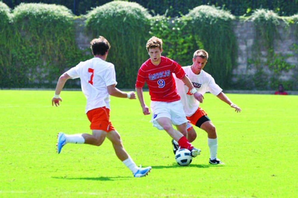 ON THE ATTACK â€” Senior forward Mike Worden runs between Bucknell defenders during AUâ€™s 3-1 win over their Patriot League rival.