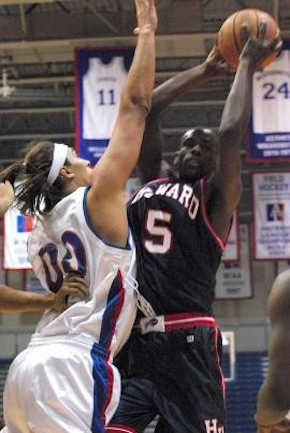 BIG BLOCK - Junior Constantin Motnii uses his height to his advantage as he attempts to block his Howard University opponent from making a pass. The Eagles were able to give their fans a real treat: an opportunity to take part in AU history and experience