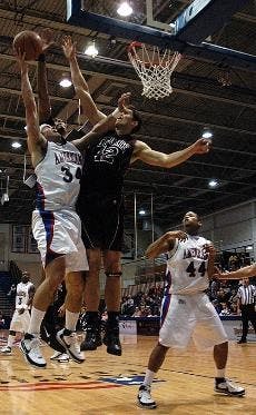 TRIPLE JUMP- Senior Travis Lay soars above two defenders as the Eagles seize a second straight Patriot League victory. AU is now tied with Bucknell University for second place in the league.