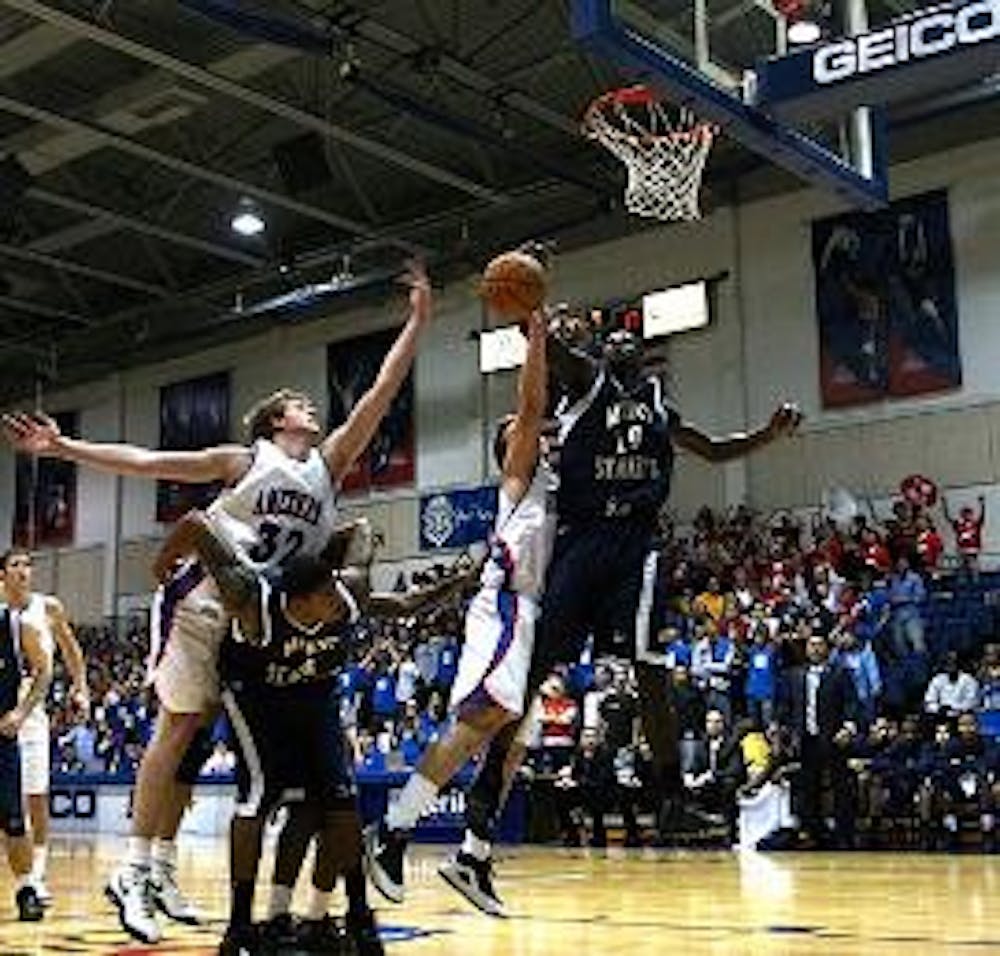 REJECTED - Senior guard Frank Borden blocks the shot of his Mount St. Mary's opponent, while freshman forward Stephen Lumpkins (No. 32) provides support, during the Eagles'  recent loss to the Mountaineers on Monday night.  The loss drops the Eagles' reco