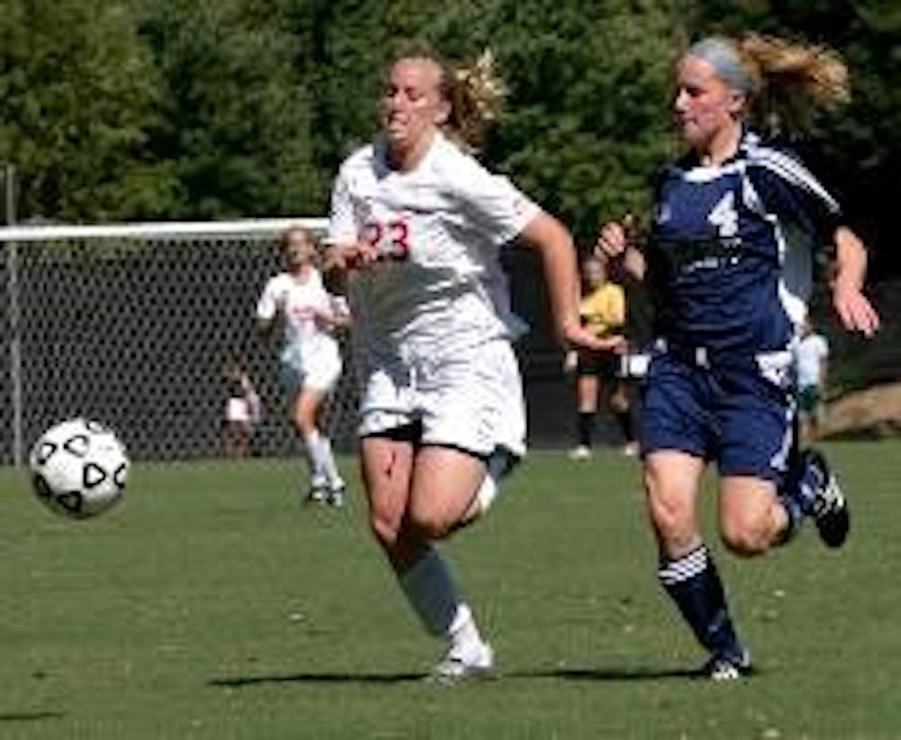 RACE FOR THE BALL- Krystn Hodge outruns her opponent to gain control of the game and go for a goal. Hodge scored two of the three Eagle goals in Tuesday's game against the George Mason Patriots.