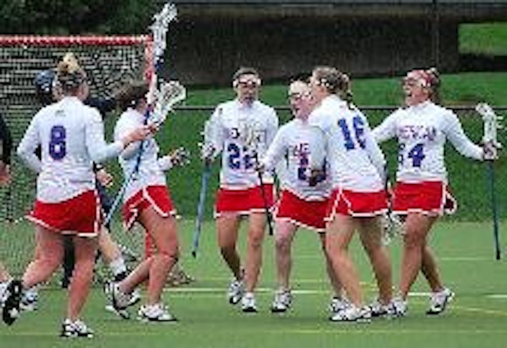 GOAL - The Eagles' offense celebrates one of Bernadette Maher's three goals.  Despite Maher's three goal performance and the Eagles' 12 total goals, the team was no match for the rain and 16 goals from the University of Richmond Spiders. The Eagles play t