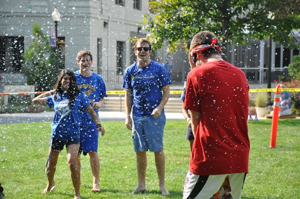 SOAK UP THE SUN â€” Students battle during a water fight using water guns and 1,000 biodegradable balloons on the quad Wednesday as part of Artemas Ward Weekâ€™s festivities. 
