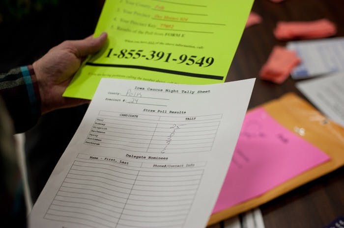 An election official counts the votes of Polk County, Iowa residents during the Republican caucus on Jan. 3.  