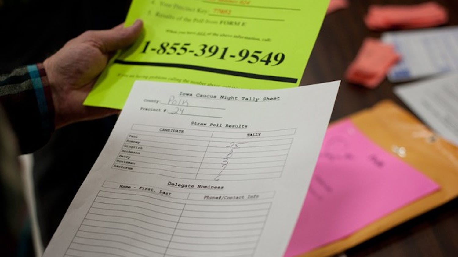 An election official counts the votes of Polk County, Iowa residents during the Republican caucus on Jan. 3.  