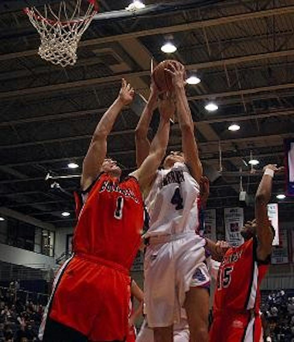 REACHING FOR THE RIM - Frane Markusovic goes for a basket as two Bucknell Bison opponents try to take him down. The Eagles stayed strong all game, pulling in their fourth straight win last night.
