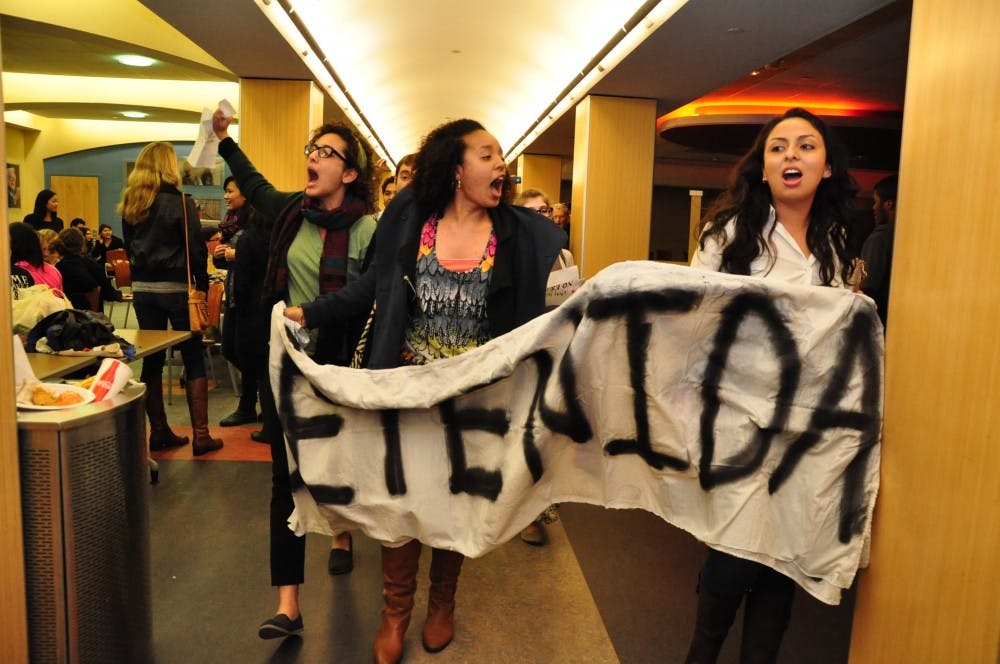 Students protest Brewer's speech