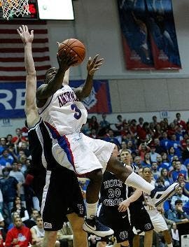 LAY-IN - Senior point guard Derek Mercer goes up for a lay up against a College of the Holy Cross defender in the Eagles 56-50 win. Mercer finished the game with 11 points on 4-12 shooting. The Eagles are now 10-1 in Patriot League play and 18-7 overall.