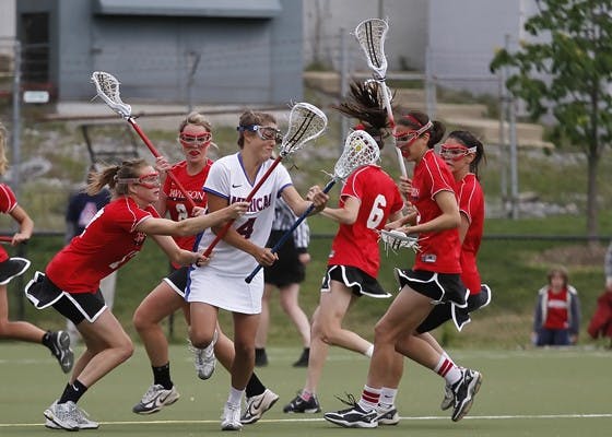 BATTLING FOR POSSESSION â€” Freshman midfielder Samantha Marshall is swarmed by the Davidson defense during Sundayâ€™s game at Jacobs Field. Marshall tallied two assists en route to AUâ€™s 10-4 victory over the Wildcats. The Senior Day win improves the Eagleâ€™s overall record to 6-9 on the season. AU will travel to Holy Cross to face the Crusaders for their final game. 