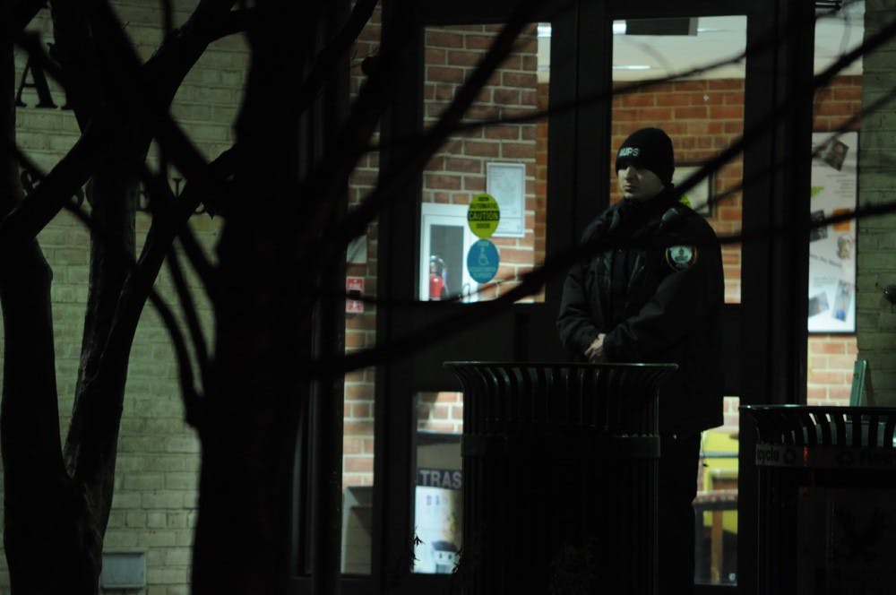 	An AU Public Safety officer stands outside Gray Hall after D.C. police searched the building.