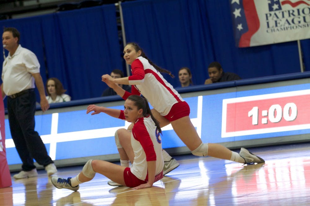 	Two AU volleyball players fall during the Eagles’ Patriot League Championship win on Nov. 24, advancing to the NCAA Sweet 16. 