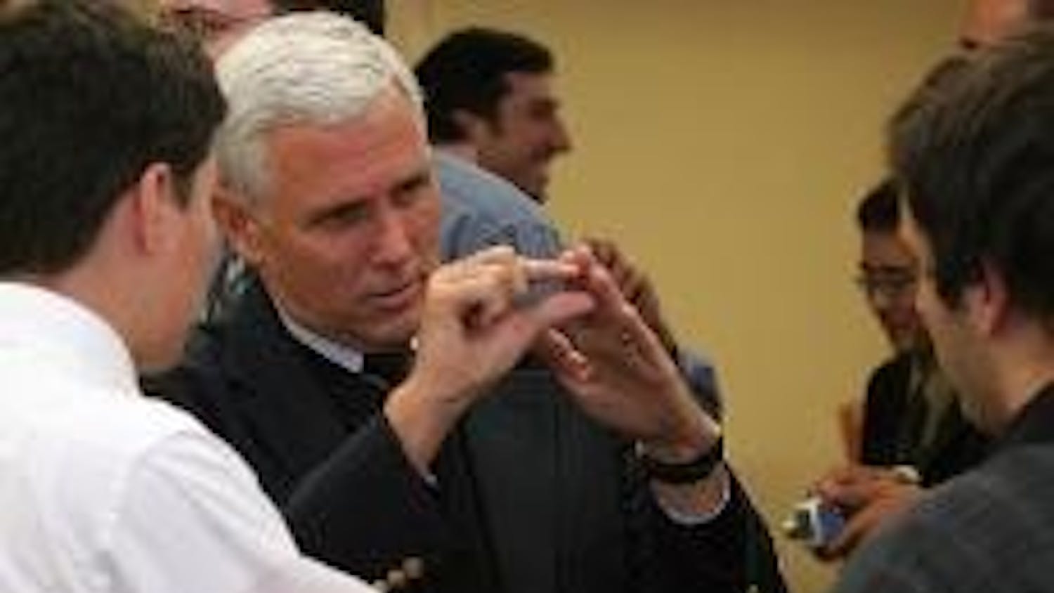 TALKING POINTS - Rep. Mike Pence, R-Ind., talks with Michael Monrroy (left) and Ajay Bruno (right) before speaking at an event sponsored by the AU College Republicans Tuesday night in Mary Graydon Center. During his speech, Pence said the Republican Party