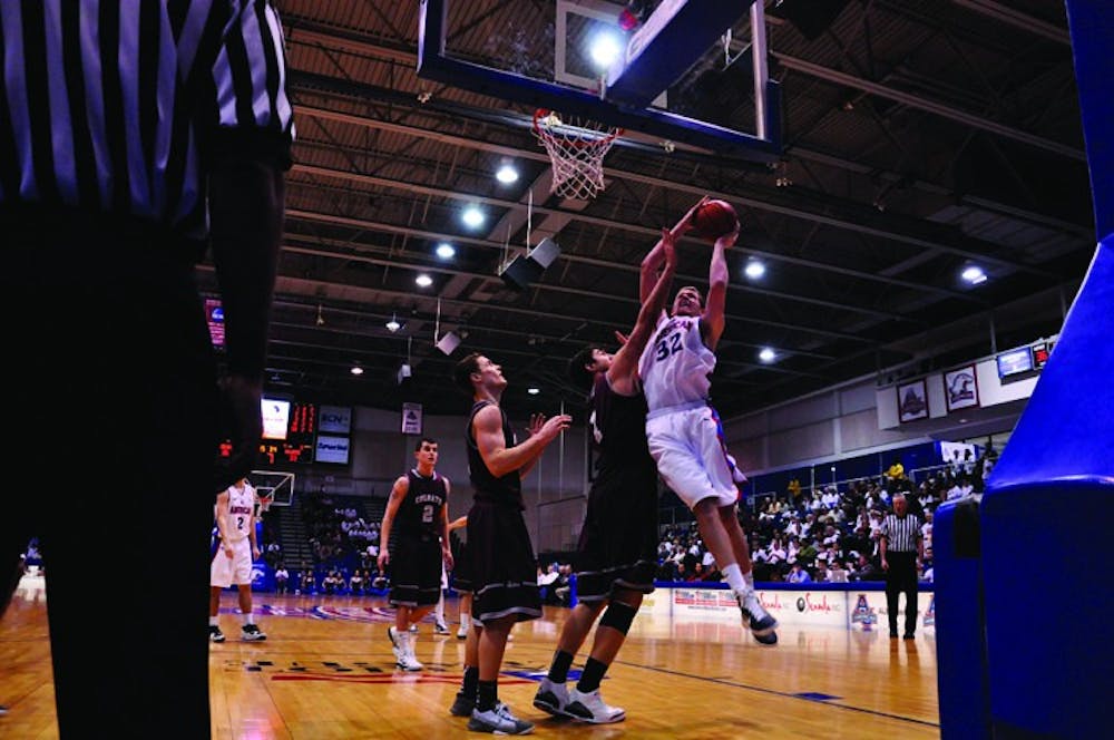 towering â€” Junior forward Stephen Lumpkins goes for two against a Colgate defender during Saturdayâ€™s 69-60 win over the Raiders. He put up a season-high 27 points in the first ever Bender Arena â€œWhite Out,â€ where fans received new Blue Crew white T-shirts.