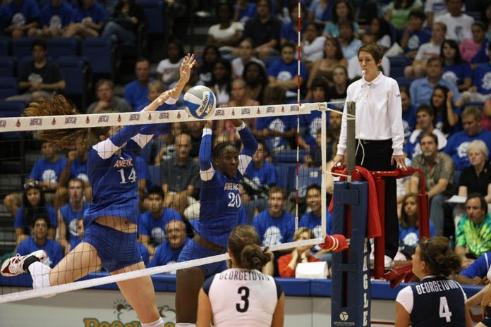 REACHING UP -- Clare Recht jumps up with Angelina Waterman to block a Georgetown shot. While almost every set was close, the Eagles couldn't pull out a win against cross-town rival Georgetown University. The team has yet to win a game, despite being ranked first in the Patriot League.