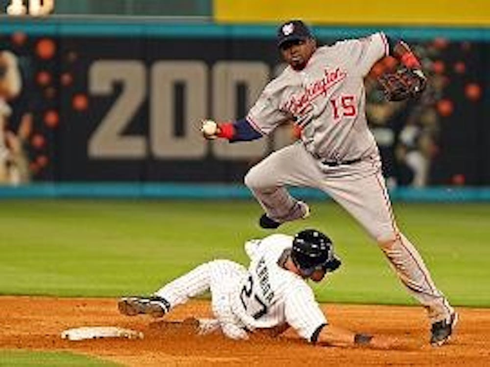 HEADS UP - Washington Nationals shortstop Cristian Guzman jumps over sliding Florida Marlins' outfielder, Jeremy  Hermida, in recent MLB play.  The Nationals are off to an 0-7 start as the rest of MLB is off to one of its most topsy-turvy starts in recent