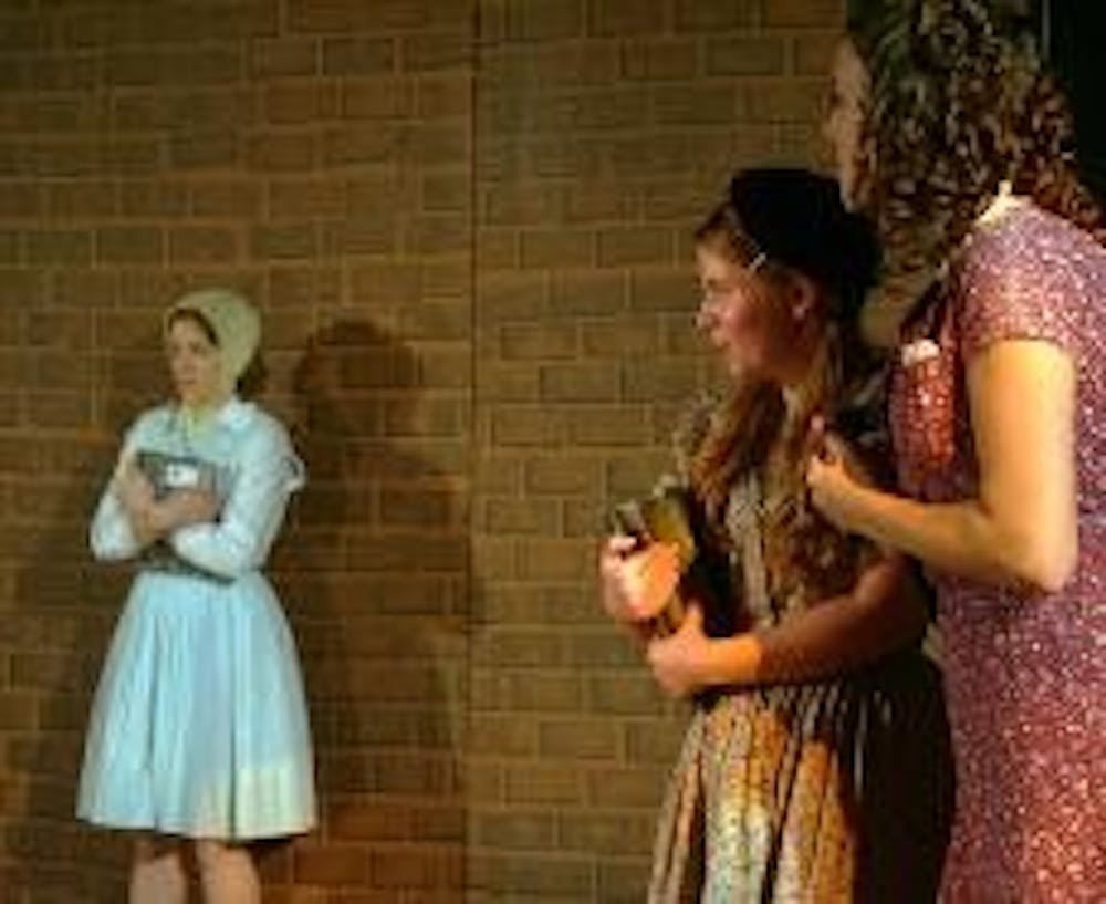 MEAN GIRLS - "The Hundred Dresses" tackles issues of alienation and peer pressure in a medium friendly to children. Here, Wanda (Laura Aristovulos) is taunted by classmates Maddie (Amy Tolbert) and Peggy (Katie Lock) for wearing the same dress every day.