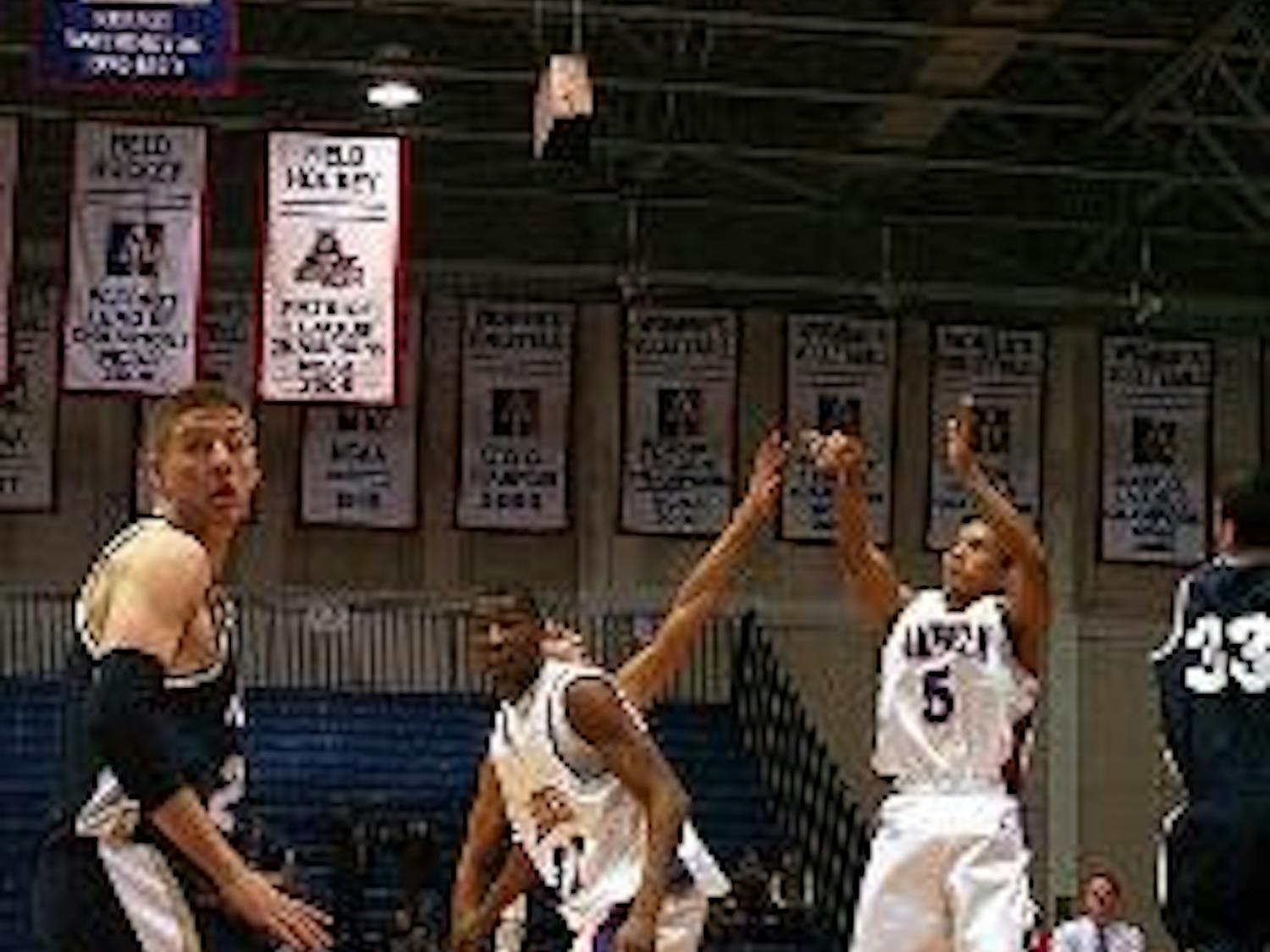 TRIFECTA- AU's Garrison Carr launches one of his trademark three-pointers last night in the game against Navy. However, it was not enough to prevent the Eagles' second straight home loss.