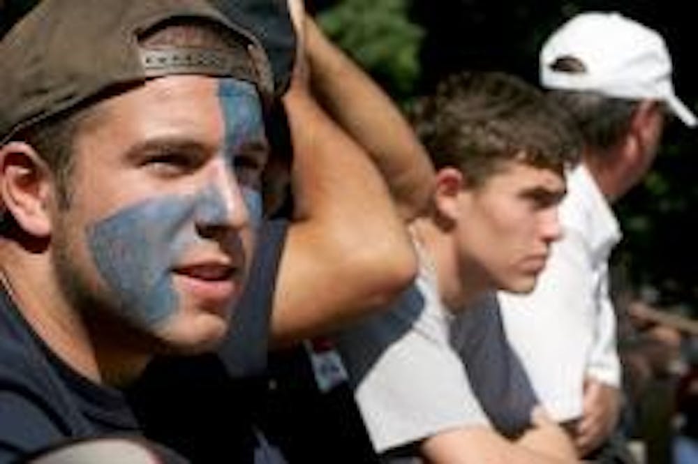 FANS IN THE STANDS - Showing their dedication to and pride in AU athletics, Eagle fans get decked out in blue to cheer on men's soccer. Phil Reeves, an event where AU fans can come out and show their school spirit, took place Saturday. 