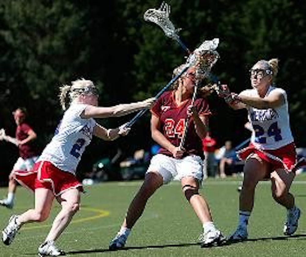 TEAMING UP- No. 24 senior defender Whitney Kovar teams up with a fellow Eagle to harass a Virginia Tech Hokie opponent during the game on Saturday afternoon.  The Eagles lost to the Hokies 19-11 despite a four goal effort by freshman Lauren Schoenberger, 