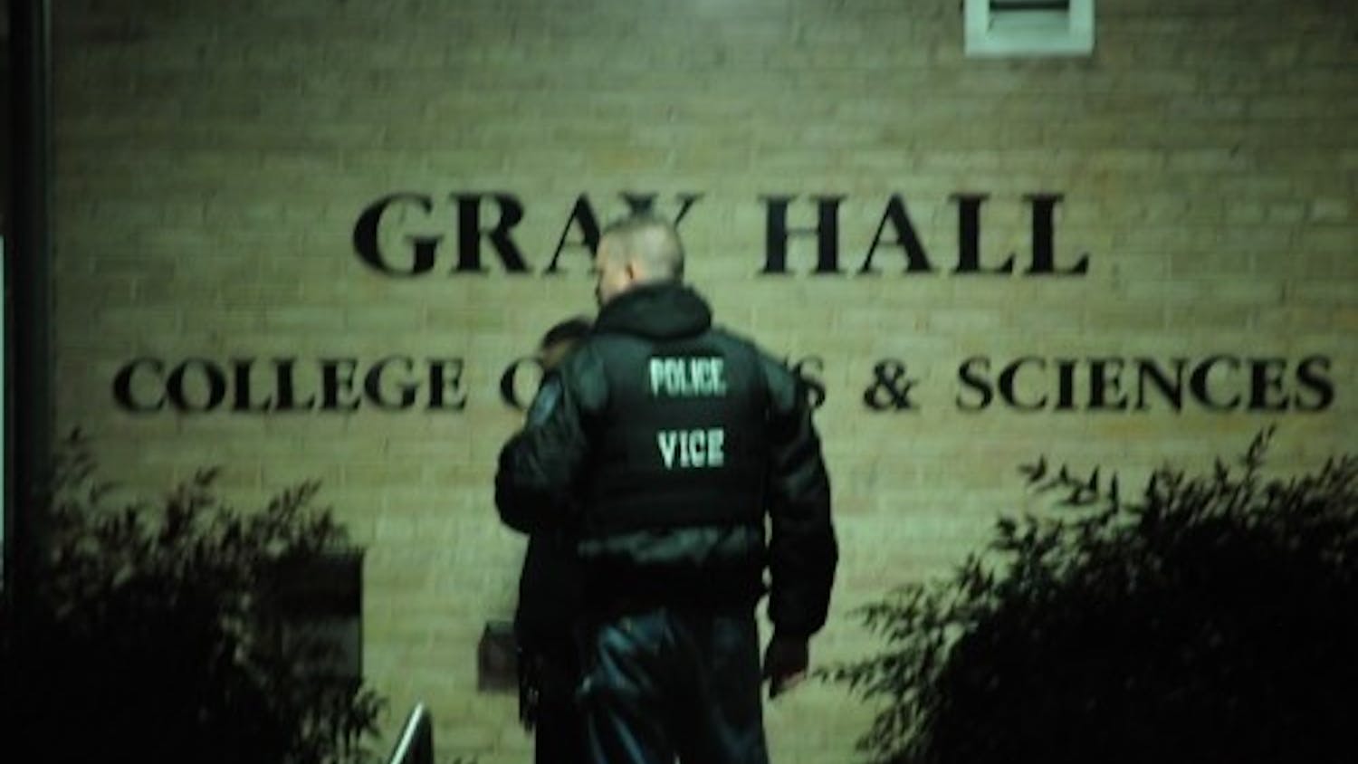 Police officer stands in front of Gray Hall during 2013 gun scare. 
