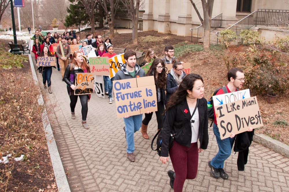 	Students urged the AU Board of Trustees to divest by marching around campus with cardboard signs on Feb. 21.