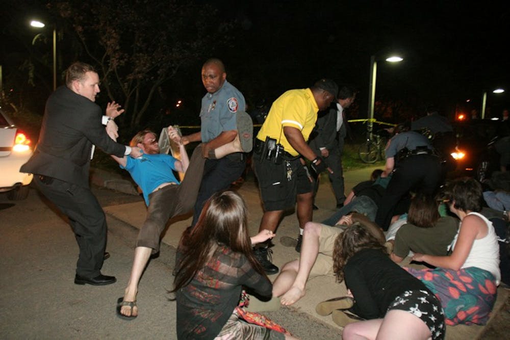 Students clash with officials while protesting a speaking event by Karl Rove in April 2007.