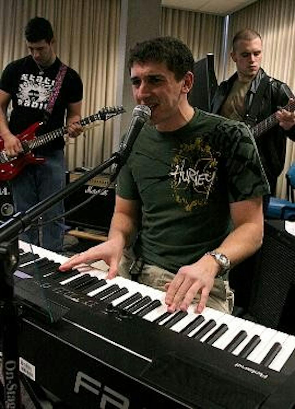 LETTS ROCK - Guitarist Al Smith (right), bassist Keith Ingram (left) and Corey Schneider (front) of CS5 jam out in the GARC in Letts Hall. The band practiced in the Letts 1 South lounge until noise complaints necessitated the move.