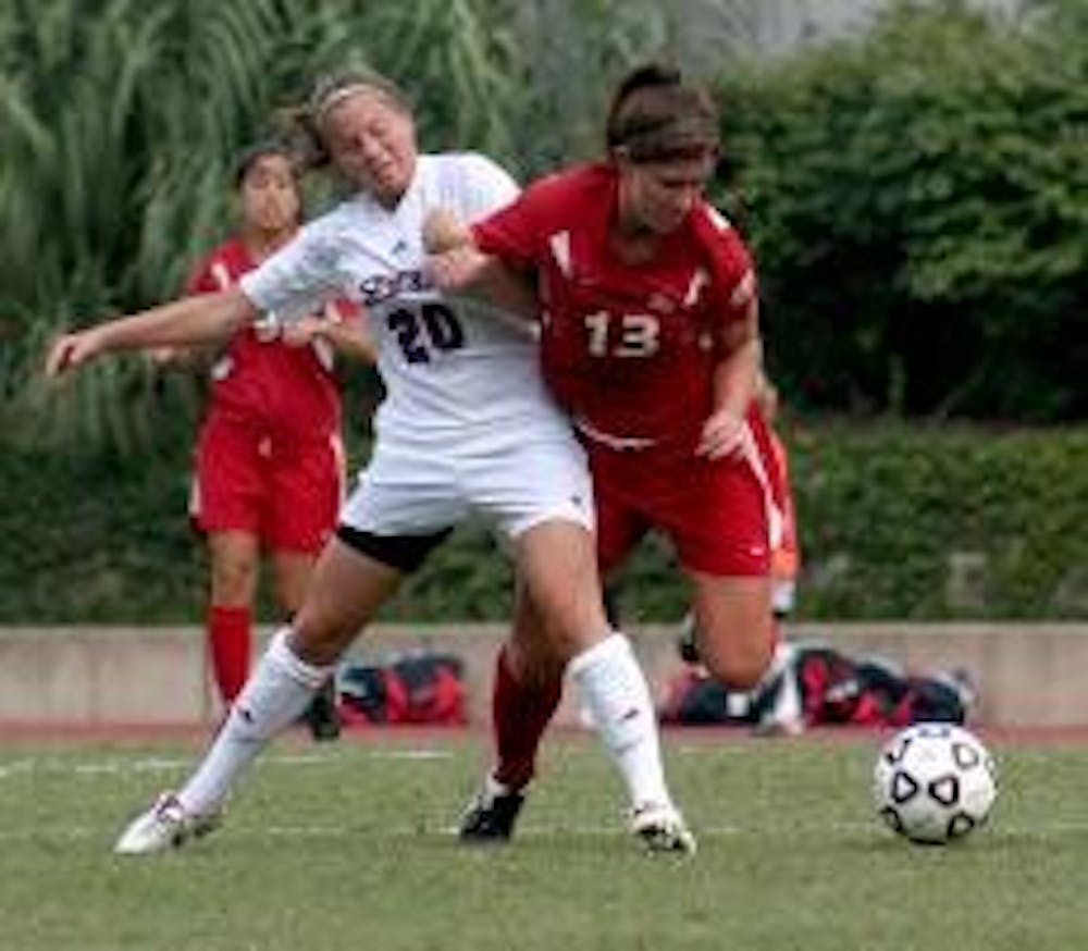 Teammates Erin Stebbins and Tatiana Bertolo work together to  defend against the University of Richmond Spiders on Sunday.