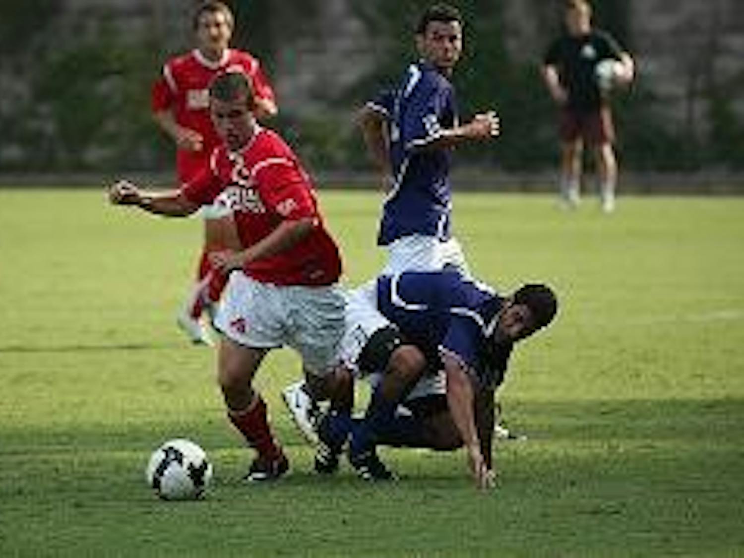 DRIBBLING BY - Sophomore forward David Menzie takes control of the ball from his James Madison University opponent during the match on Wednesday afternoon. Menzie and his Eagles teammates took home a hard earned tie over the Dukes to improve to 3-3-1 on