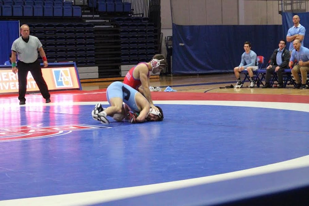 AU team captain Esteban Gomez-Rivera wrestles against Columbia's Angelo Amenta at a home match last season on Jan. 31, 2016.