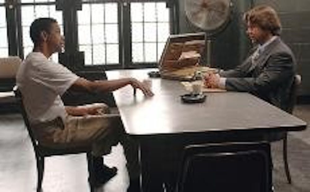 BIG PIMPIN' - Denzel Washington (left) and Russell Crowe face off against each other in "American Gangster," the latest film by director Ridley Scott. Washington plays a drug lord who smuggles heroin in the coffins of dead soldiers returning to the United