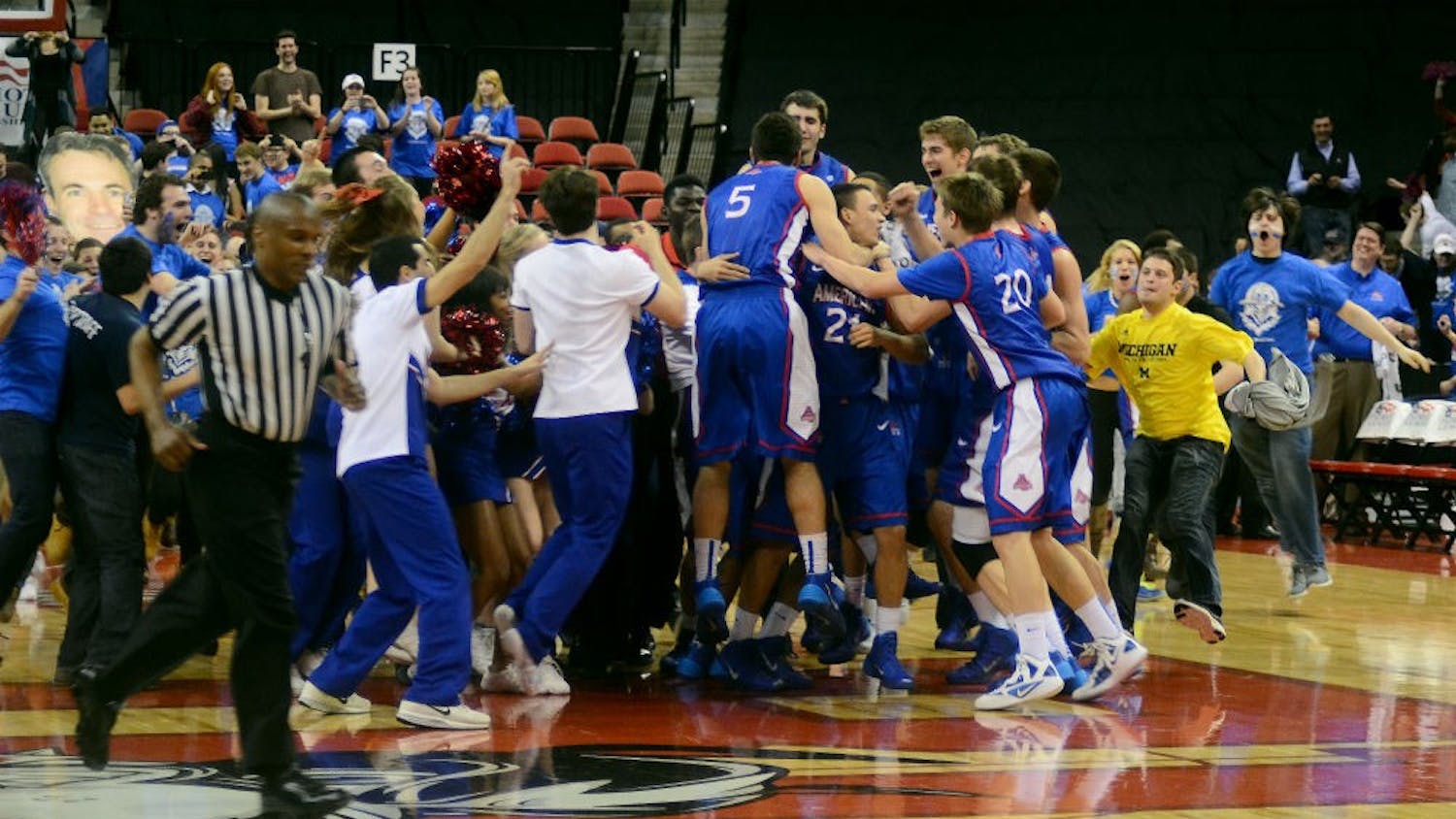 	AU fans and basketball players celebrate the team&#8217;s victory against Boston University on March 12.