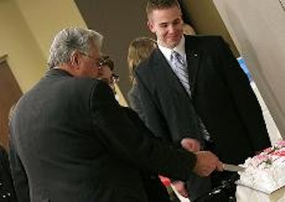 CUTTING THE CAKE - Former House Majority Leader Dick Armey and AU College Republicans President Will Haun cut the Republicalooza cake at an event held Tuesday night. Republicalooza, an annual event, provided College Republicans with the opportunity to con