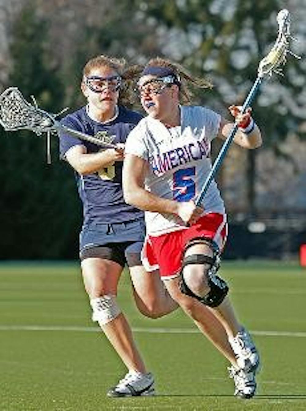 EAGLES FALL AGAIN - In this file photo, senior Leslie Fischer races up the field against George Washington University. She was the star player of American's 16-12 loss to their Patriot League rivals Holy Cross. Fischer scored a team high three goals on th